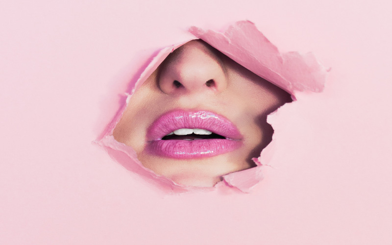 Lips behind pink paper - Ian Dooley