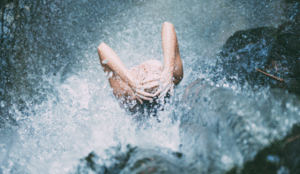 woman in waterfall | Beach Tomato