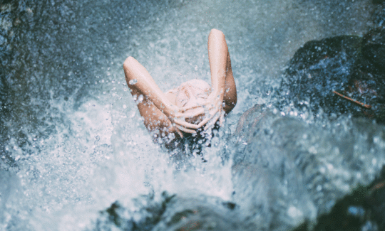 woman in waterfall | Beach Tomato