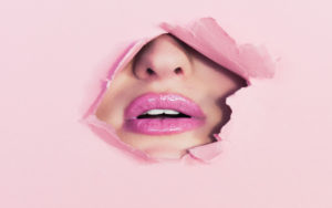 Lips behind pink paper - Ian Dooley